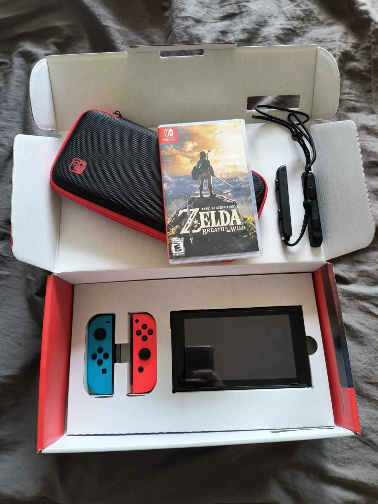Nintendo Switch console with Zelda BOTW game and carrying case thumbnail