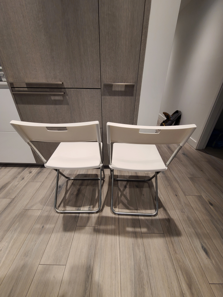 white Ikea plastic folding chairs.