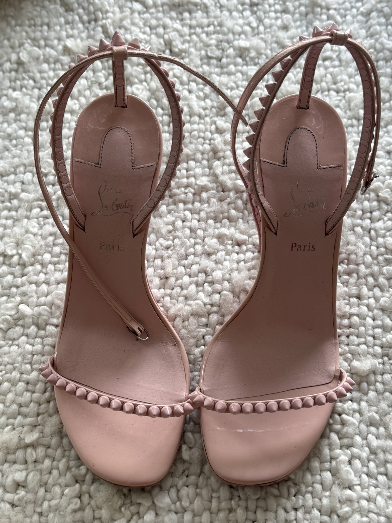 Louboutin pink spike heels.