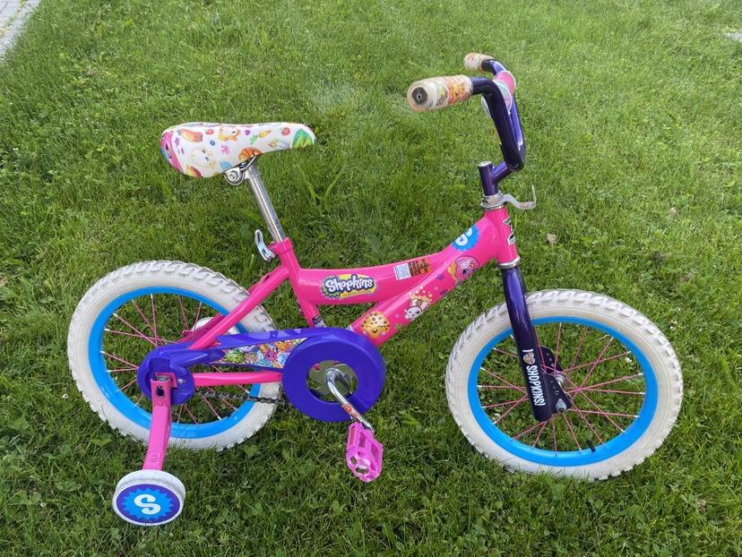 Girls bike with training wheels and basket