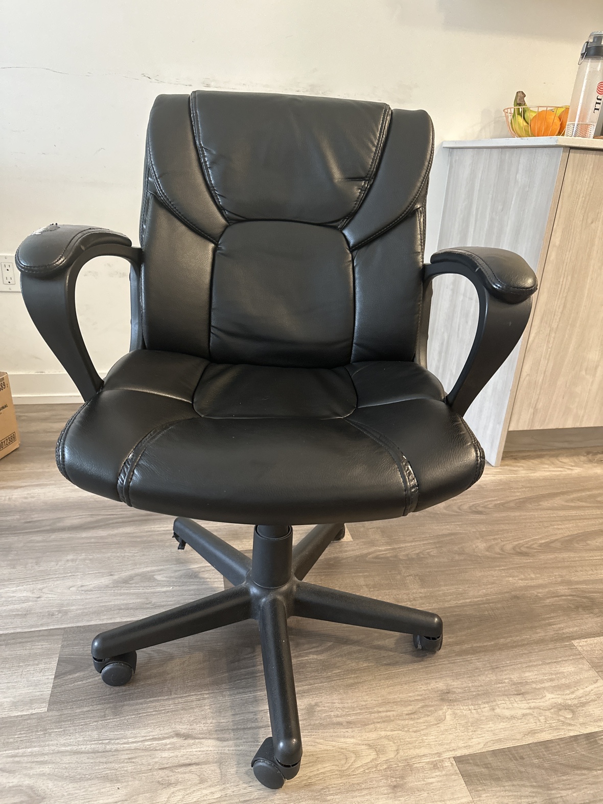 Leather office chair (black) with adjustable flip-up.