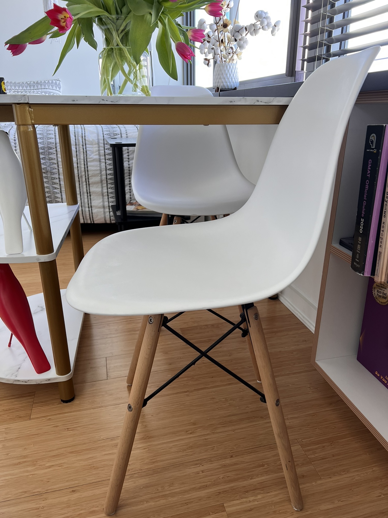 White plastic chair with wooden legs