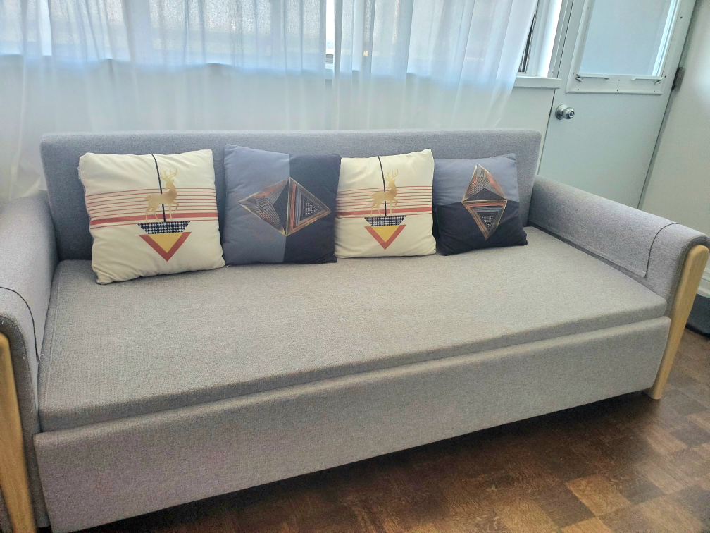 Light grey king-size sofa bed with 4 cushions