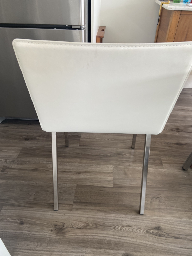 2 almost new white pleather chairs from CB2 on Robson st.