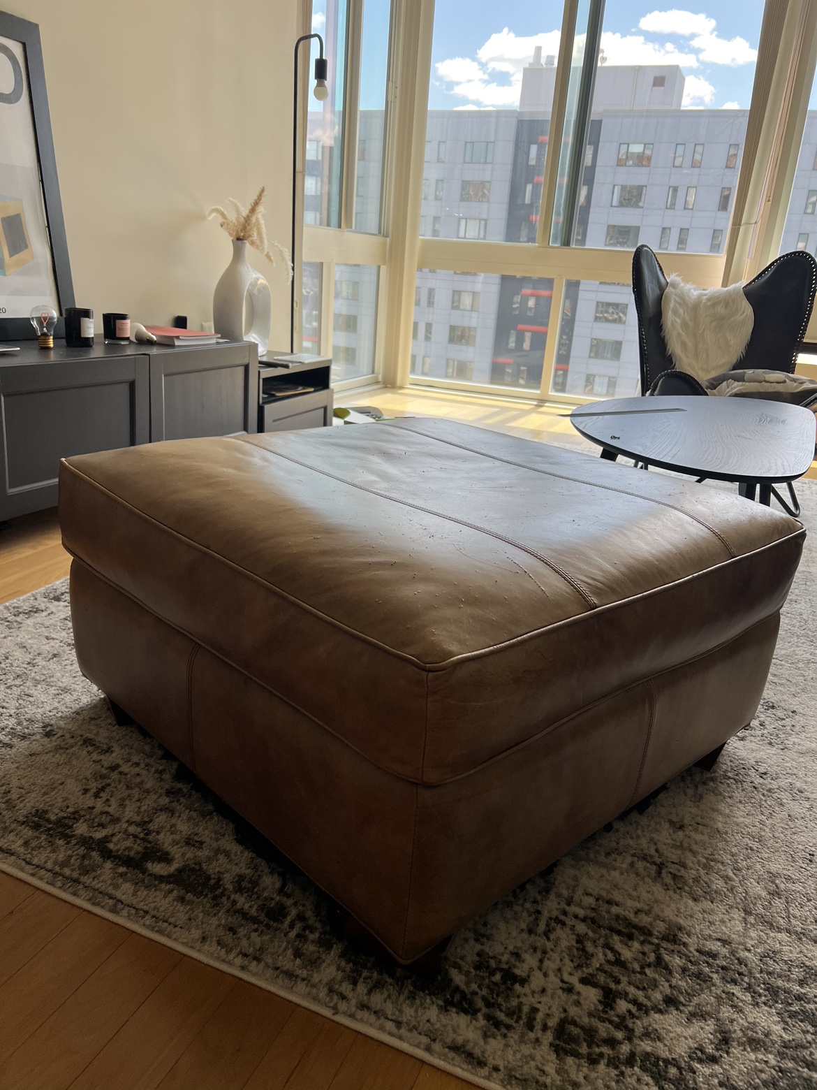 Real leather ottoman. (Moving Sale)