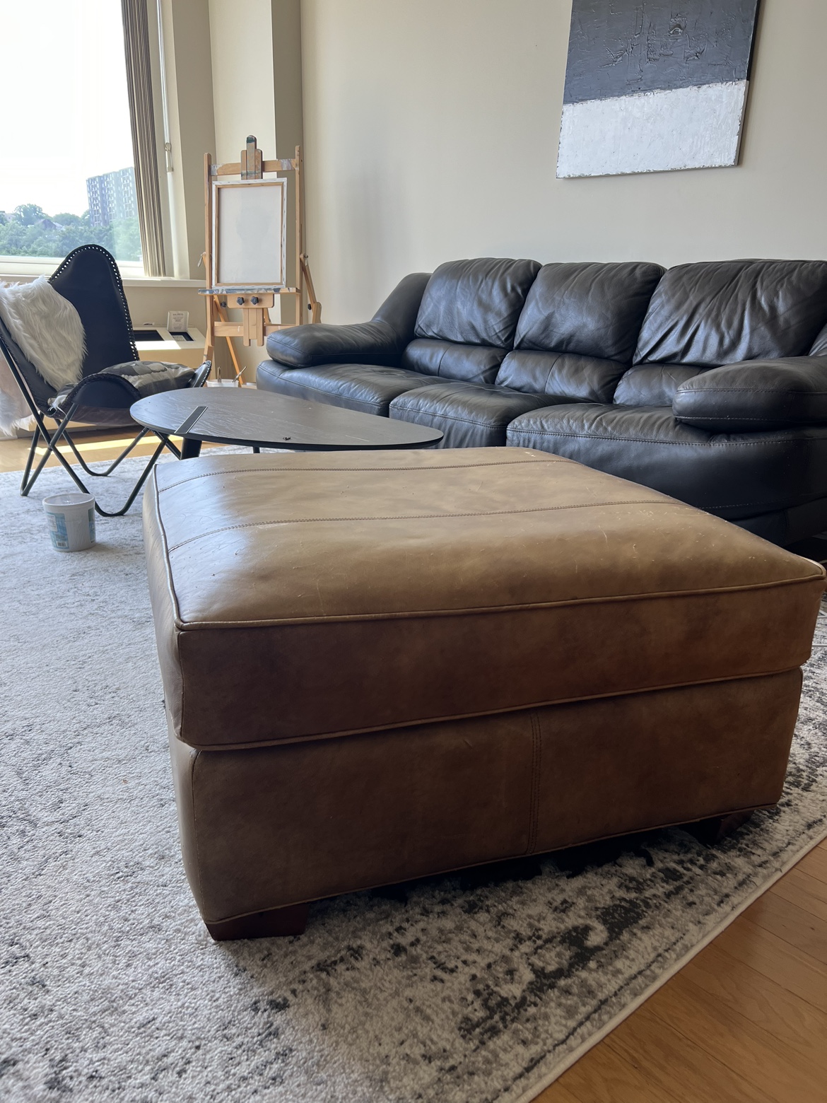 Real leather ottoman. (Moving Sale) - photo 2