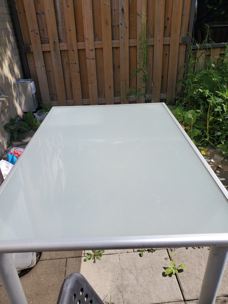 Outdoor glass top table.