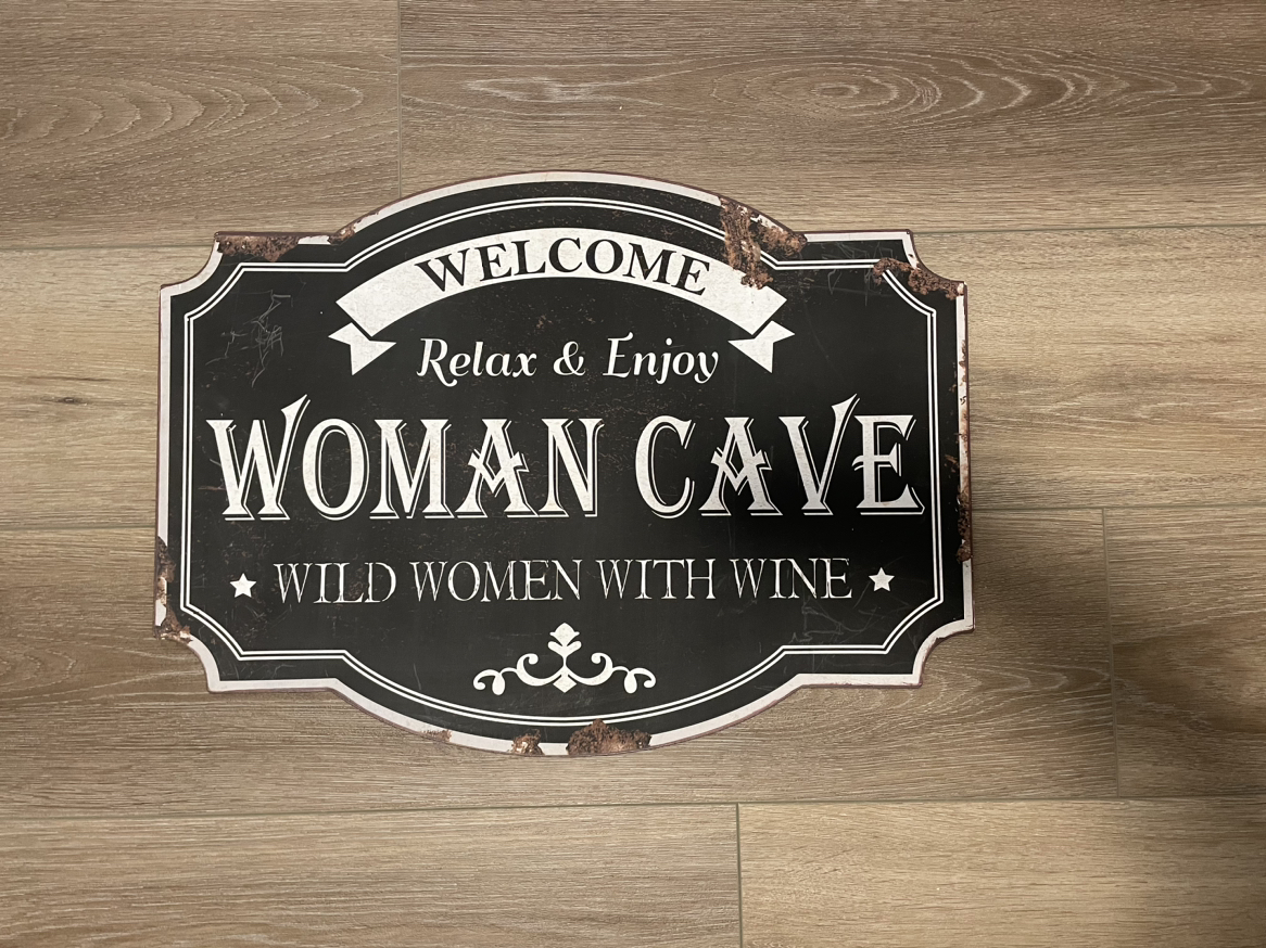 Woman cave metal sign