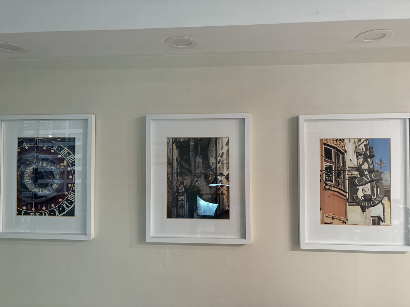 Three white photo frames