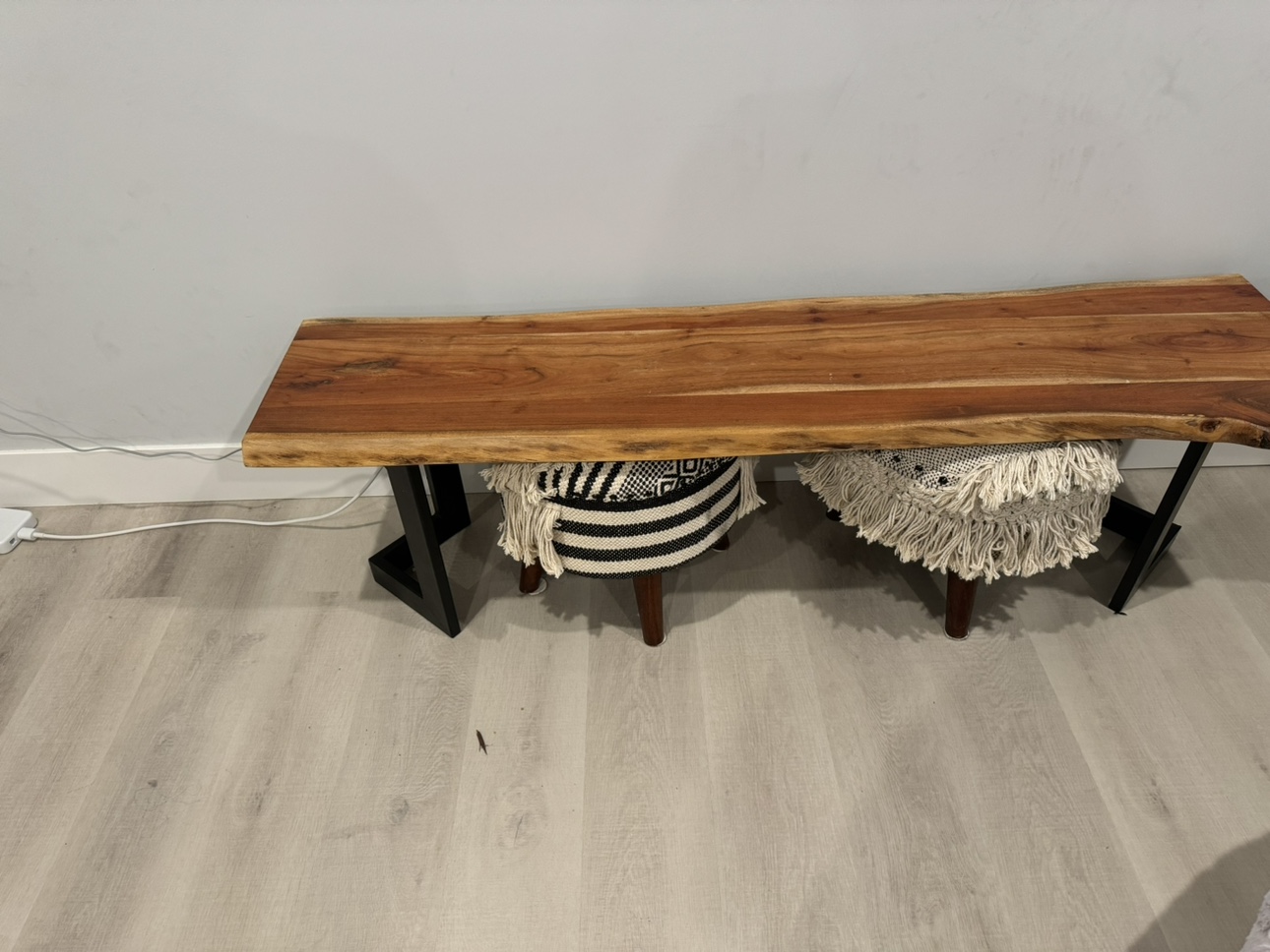 Solid wooden bench with metal legs.