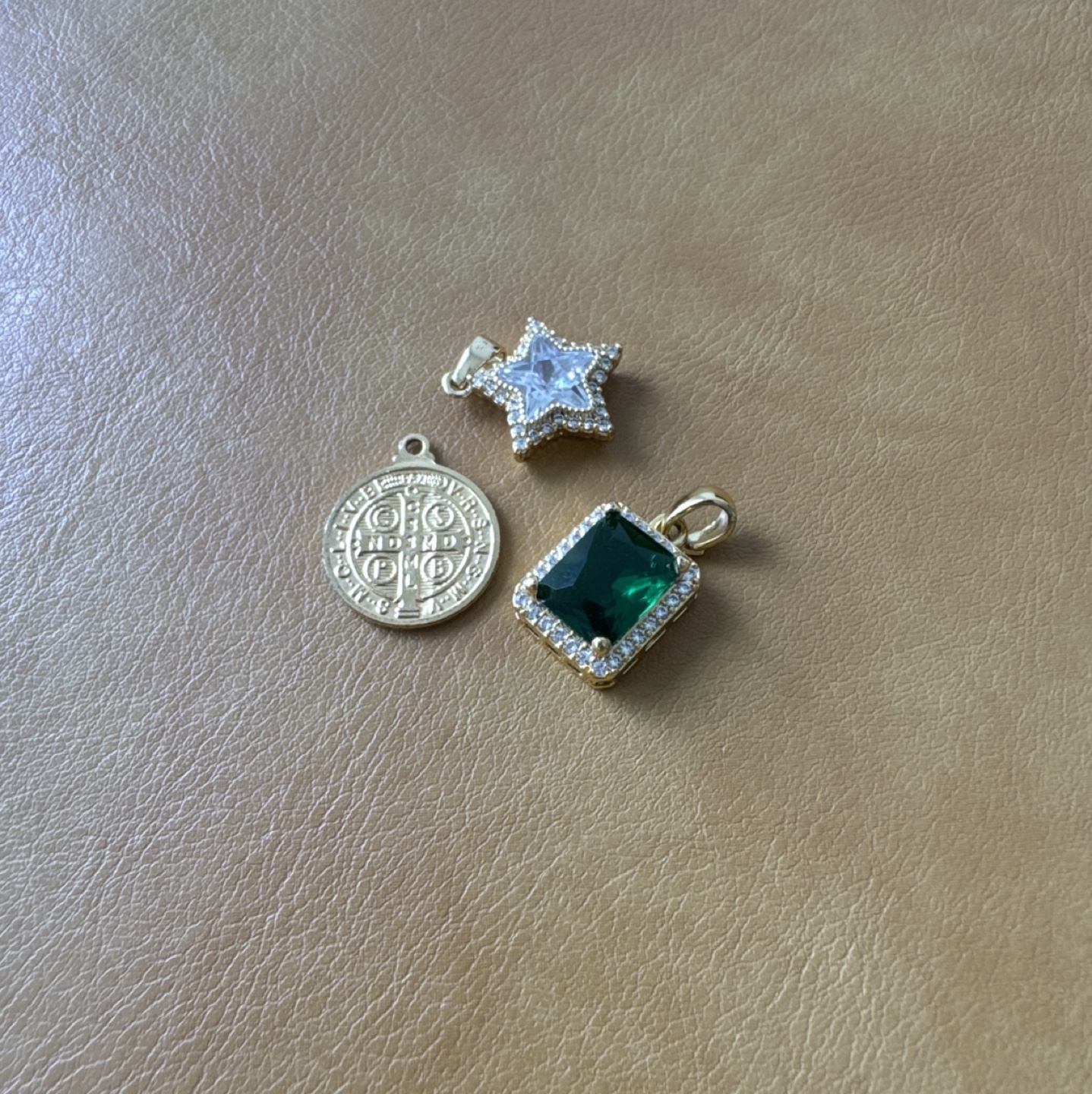 three gold necklace charms thumbnail