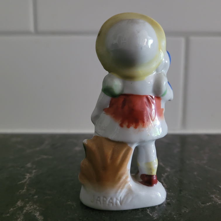 Girl holding doll and grapes figurine - photo 2