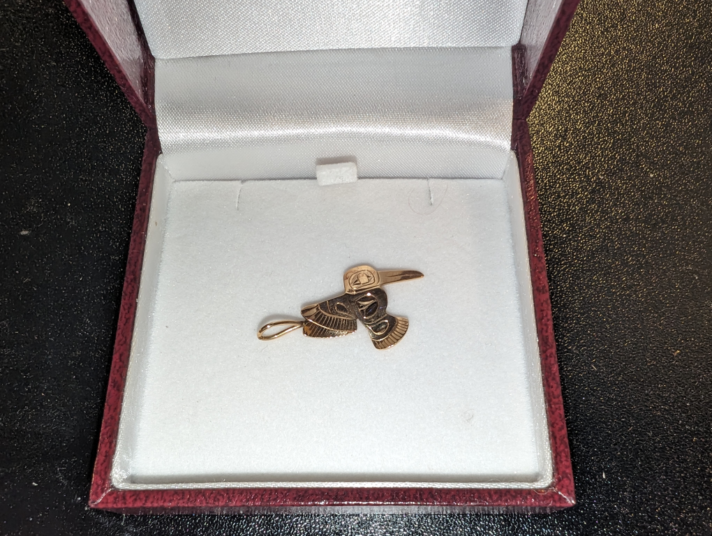 14k gold hummingbird pendant by Tlingit artist Fred Myra