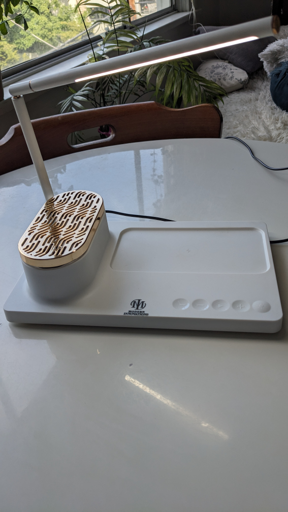 Touch desk lamp with wireless charging station and speaker