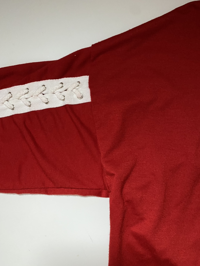 Red long sleeve shirt with white laces on sleeves image indicator(3)