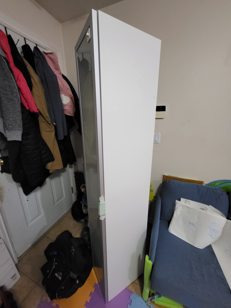 Tall slim white cabinet with metallic door