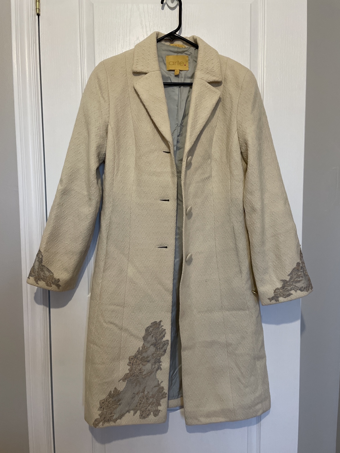 Cream color fall designer coat.