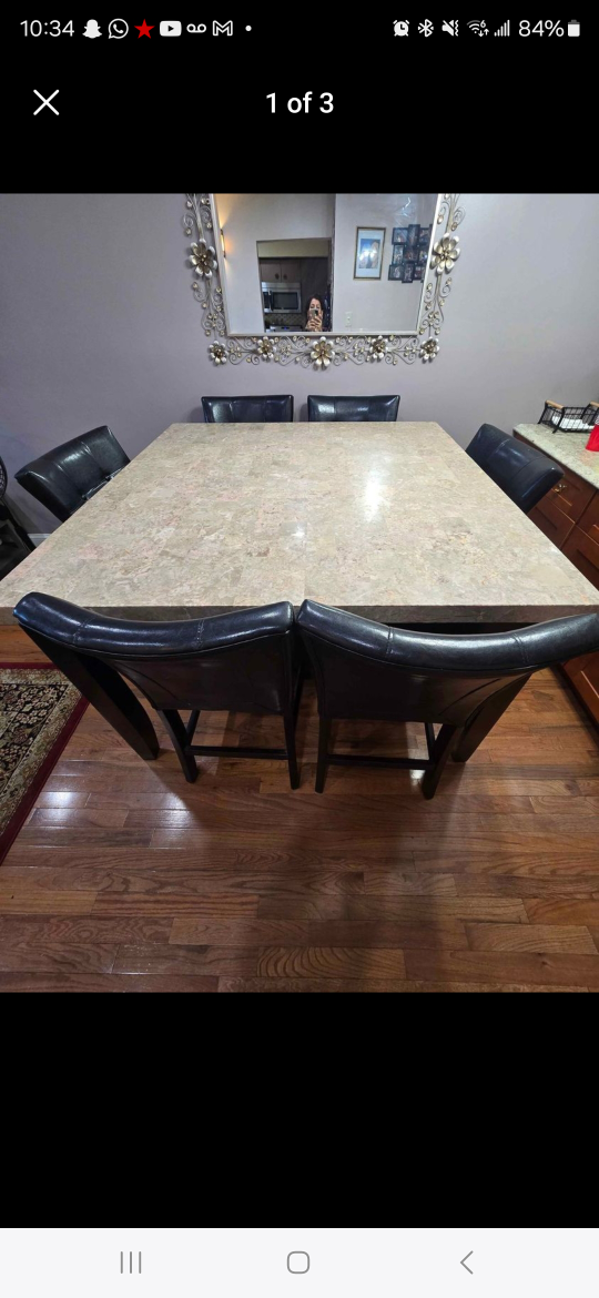 dinning tablet with granite top with 8 leather chairs