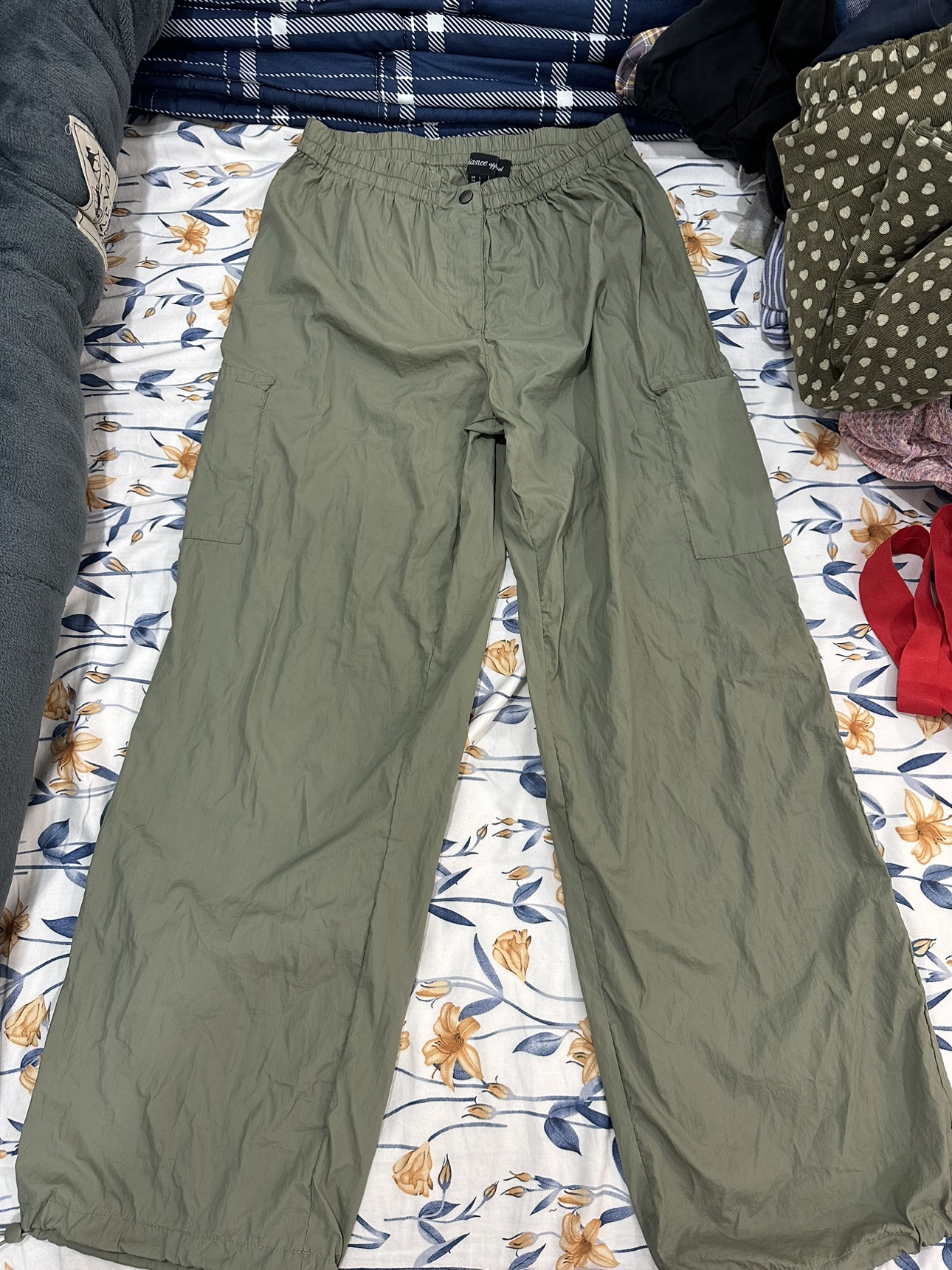 parachute cargo pants with drawstrings on the leg.
