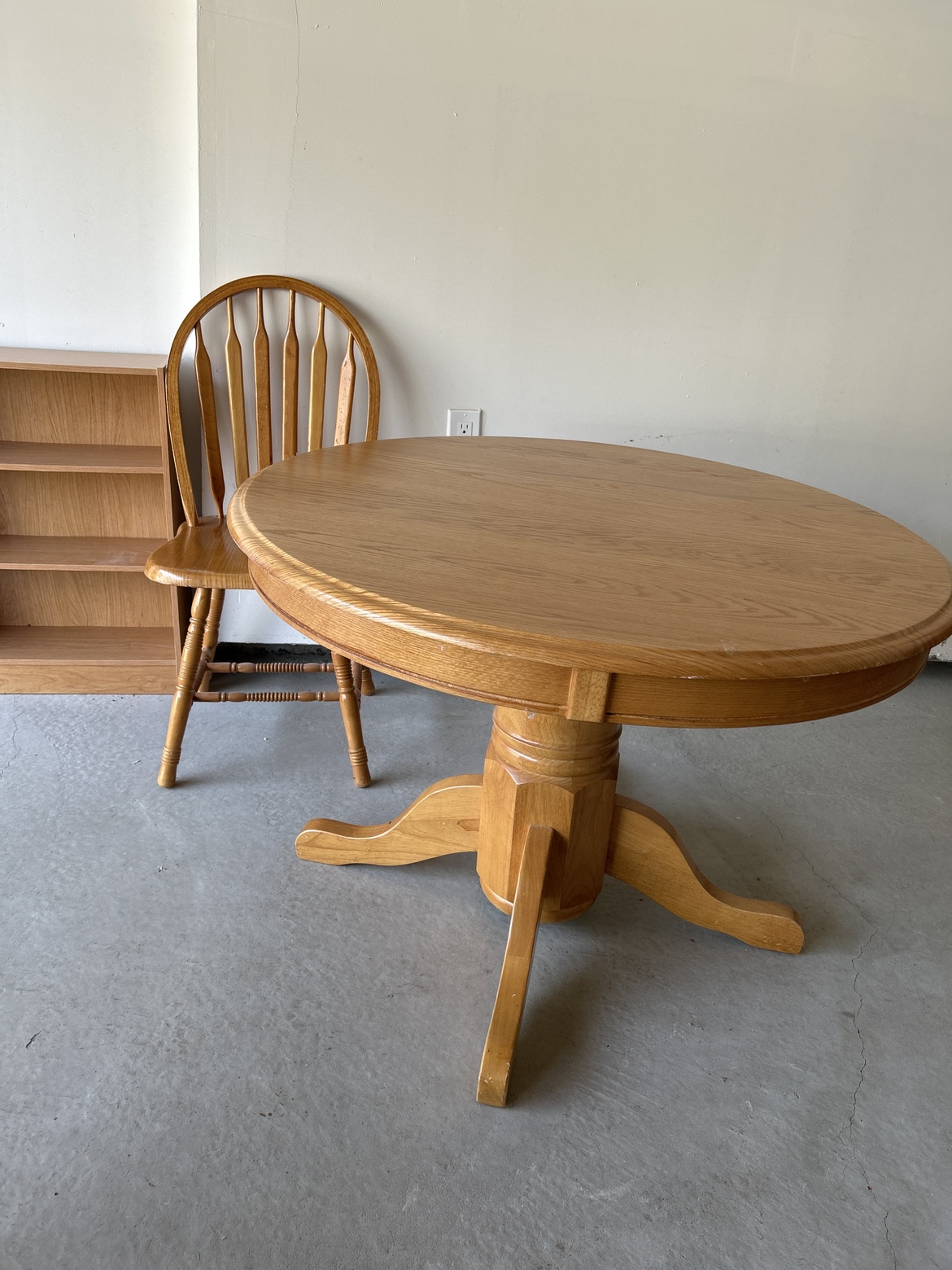 Round Table with one Chair and Bookcase