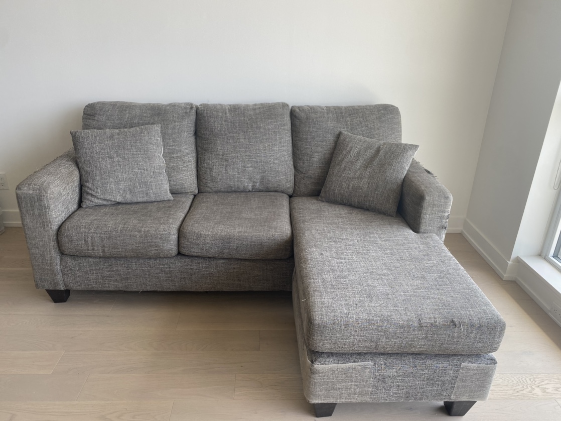 3-person L-shaped grey couch with matching cushions thumbnail