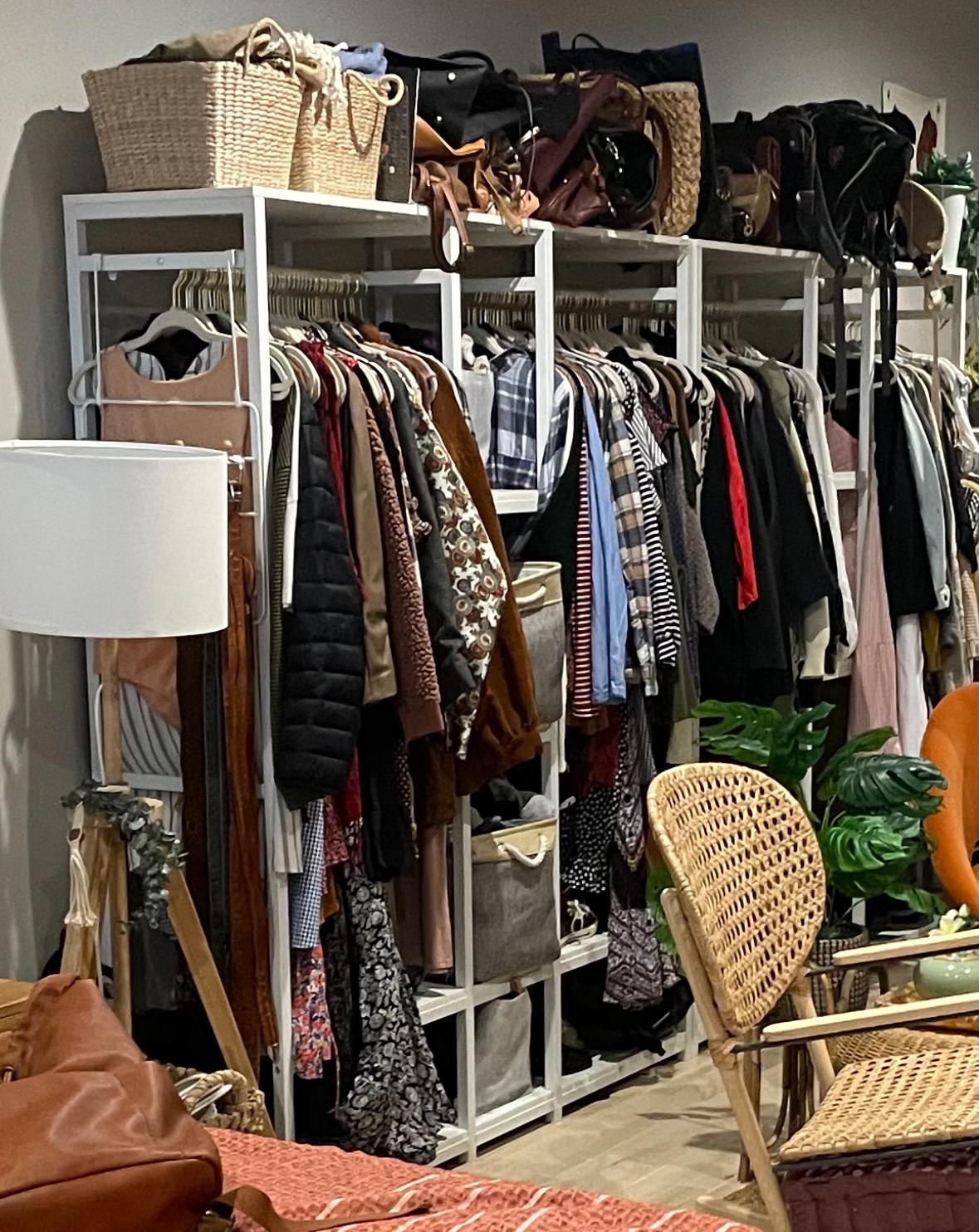 Two white wardrobe clothing racks with shelves