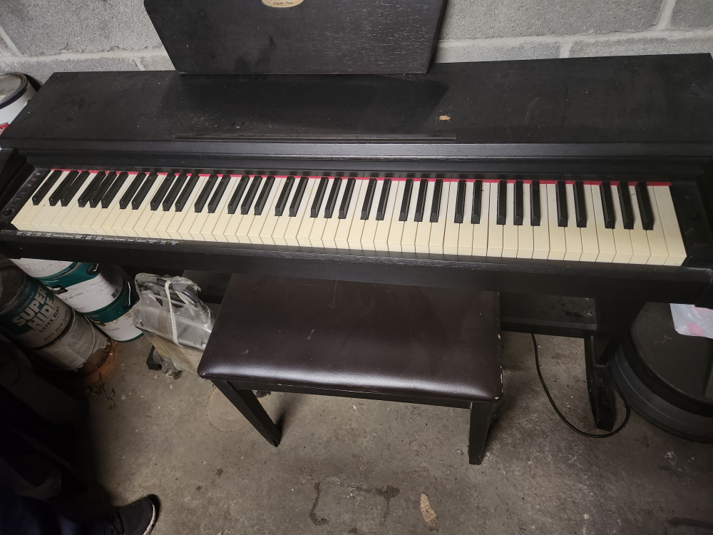 Black piano with stool. Good condition.