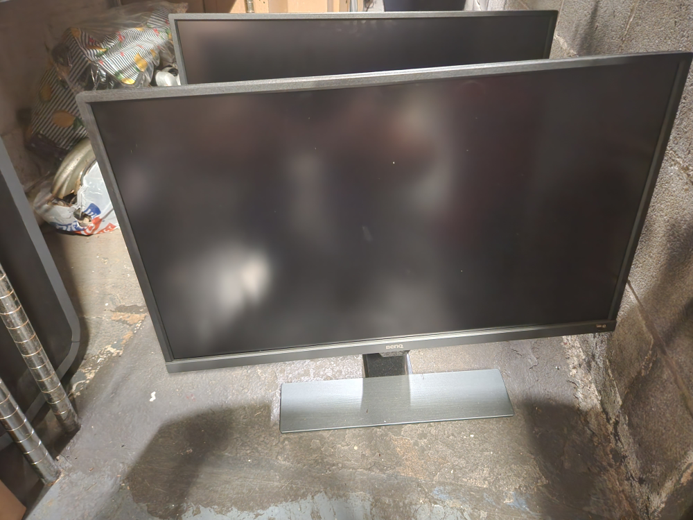 Two 32 inch black monitors. Benq brand.