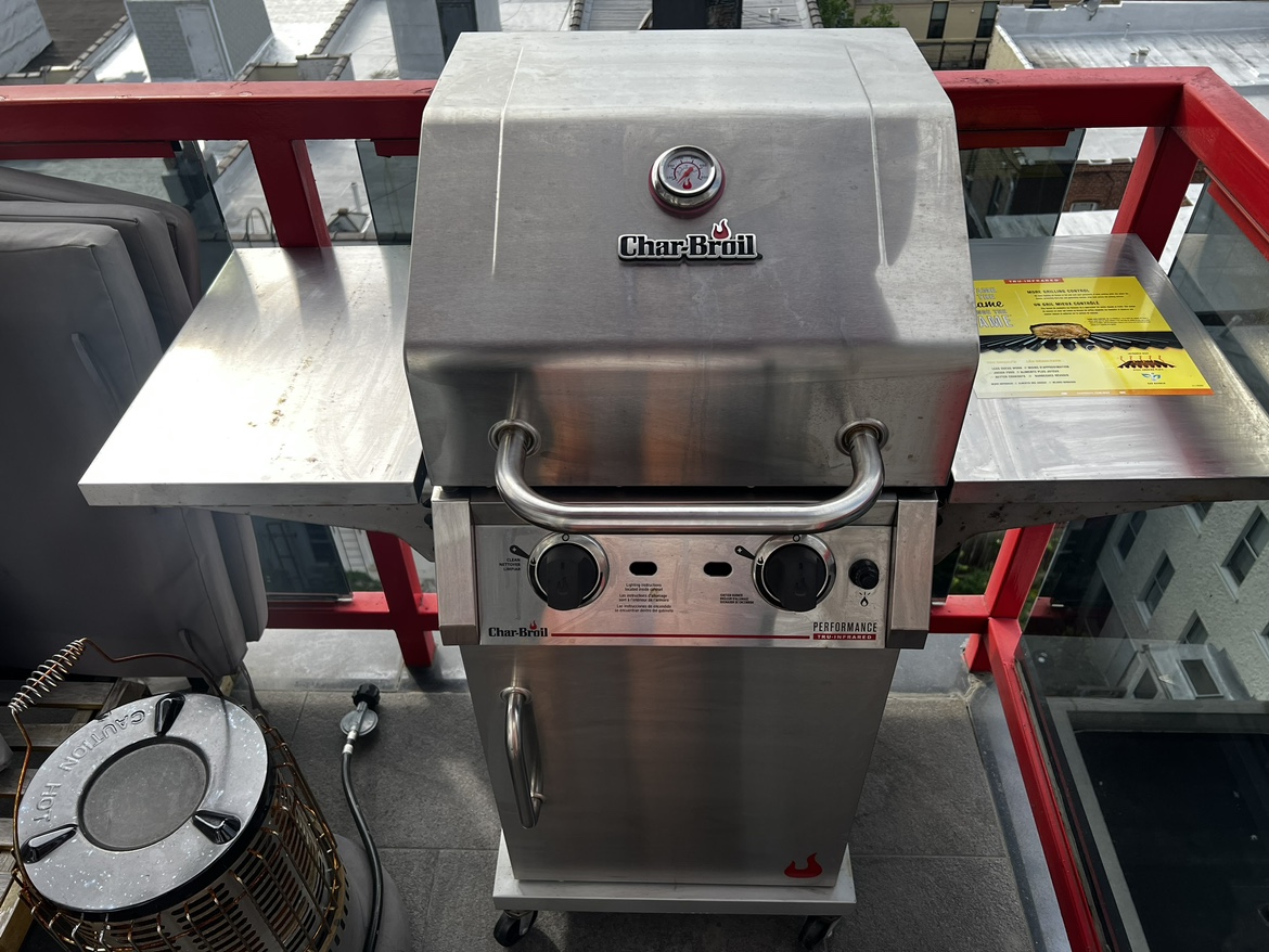Char-Broil 2-burner grill plus an empty propane tank