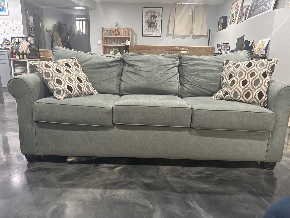Teal Couch with two Pillows