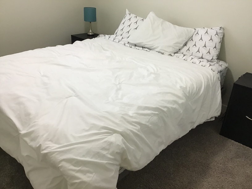 Queen size bed with two night tables