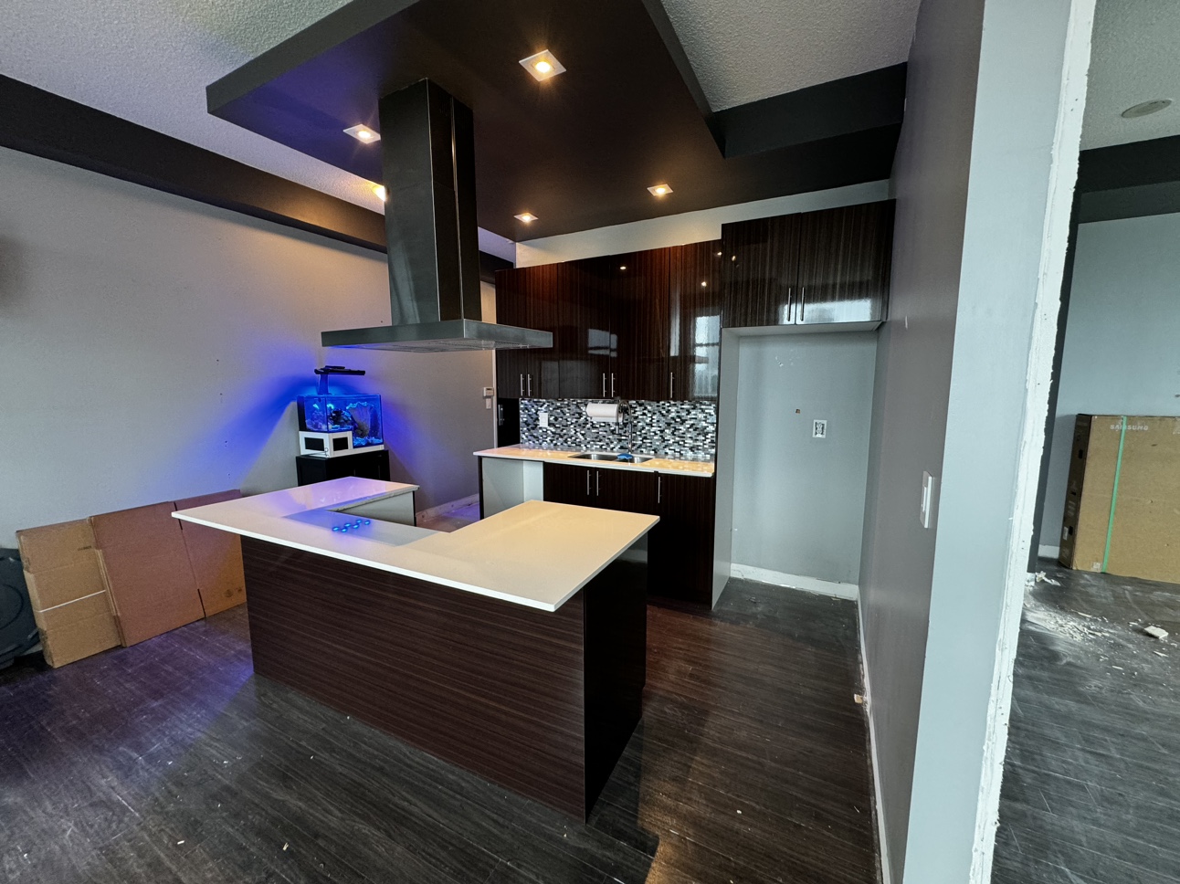 Kitchen Cabinetry island, quartz counters, sink, range fan