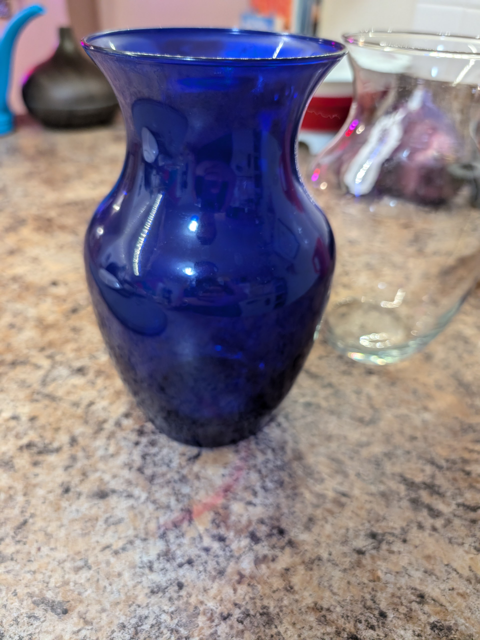 2 glass vases. 1 blue and 1 clear image indicator(3)