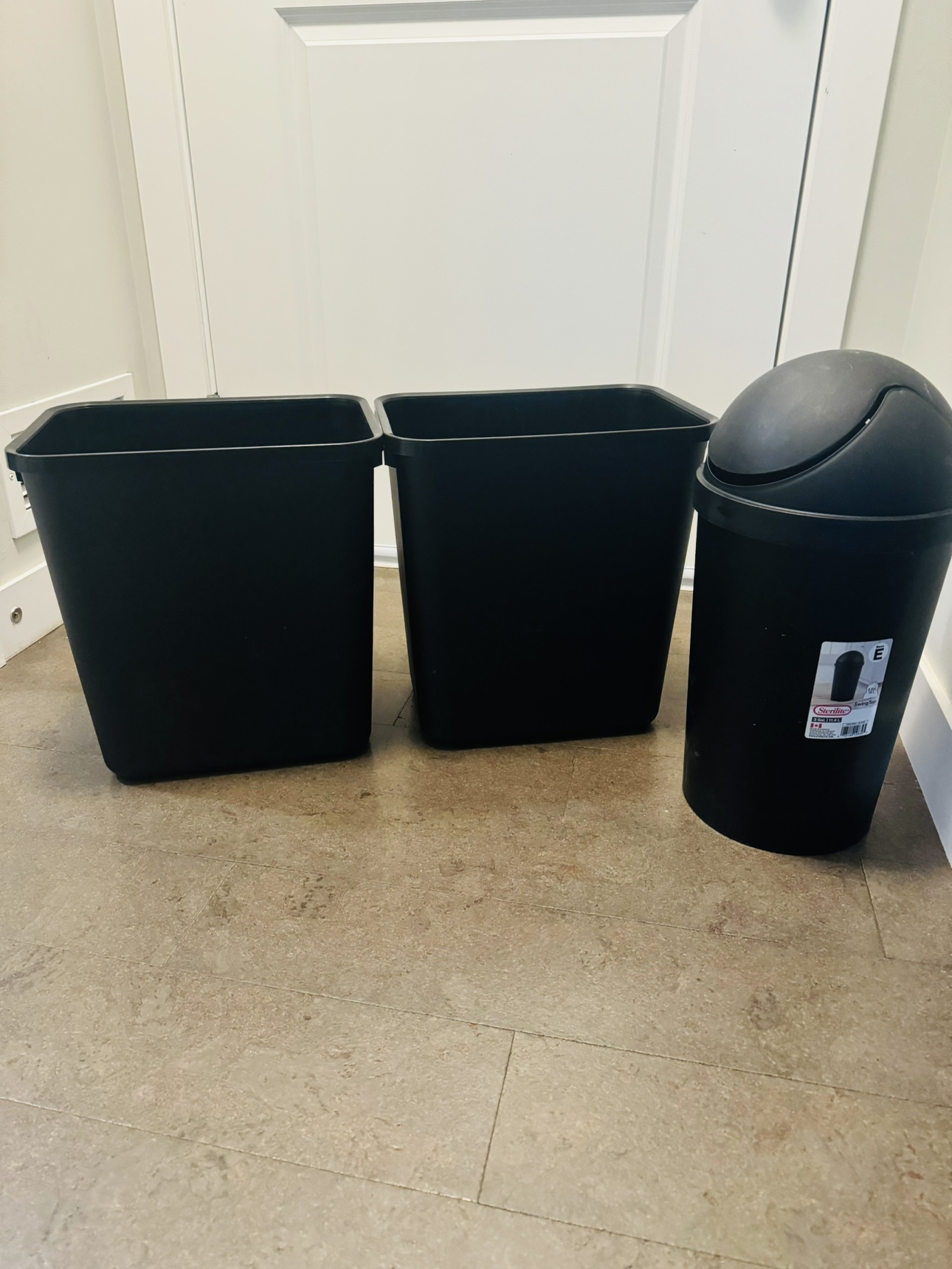3 Black Garbage Cans and 1 white dishes rack
