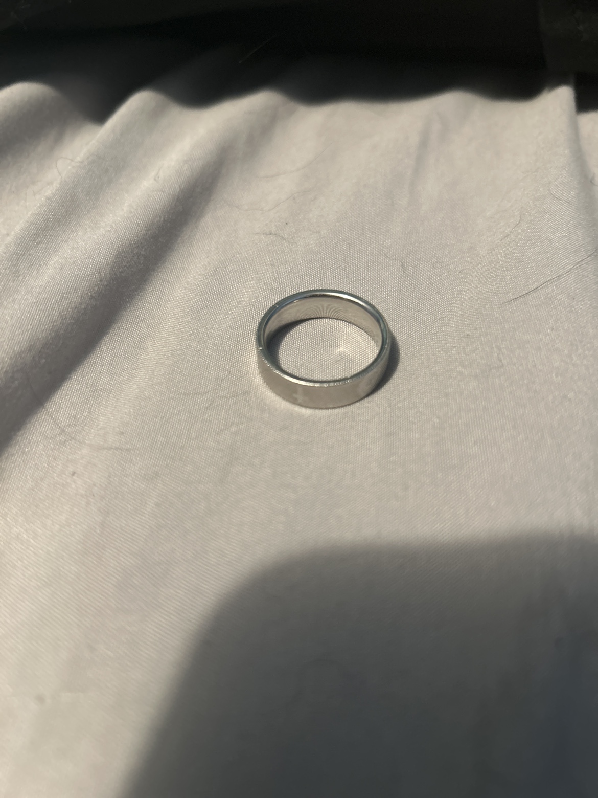 Silver ring with cross on it