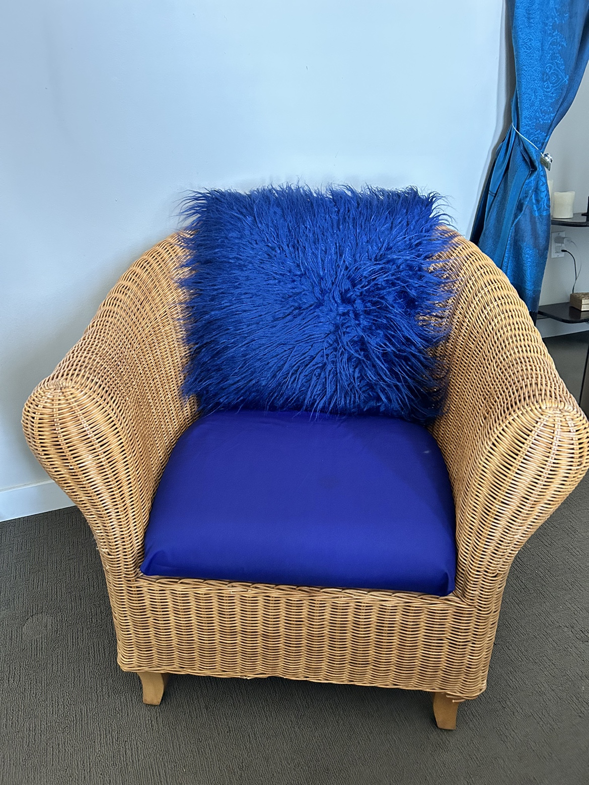 Rattan chair with blue cushion
