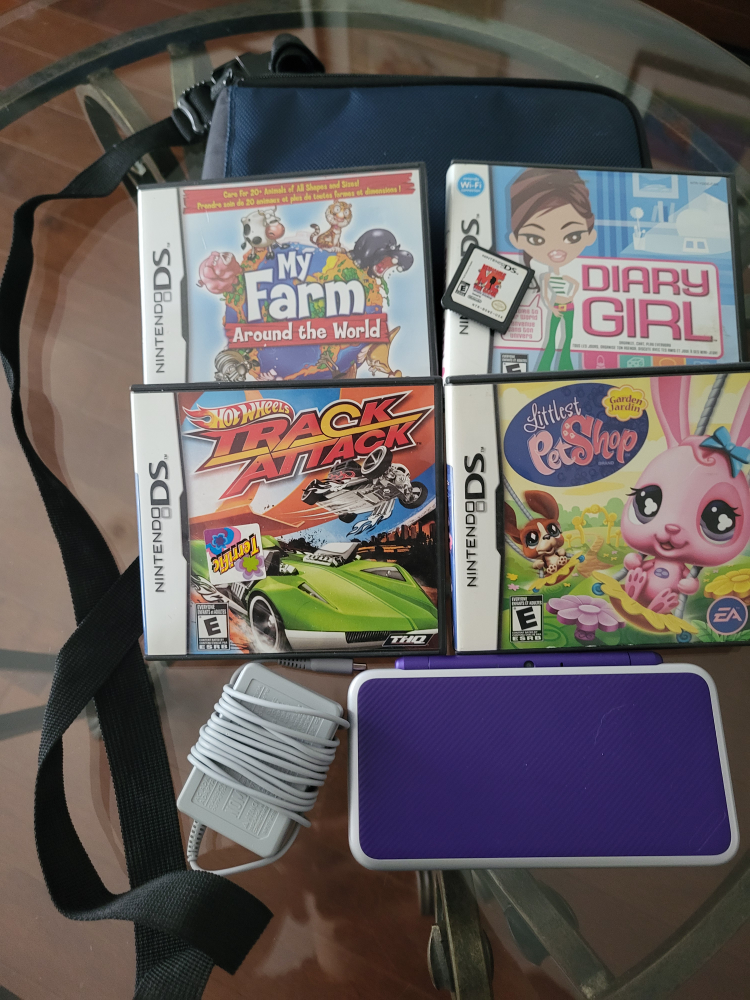 Purple Nintendo 3DS XL with DS Games