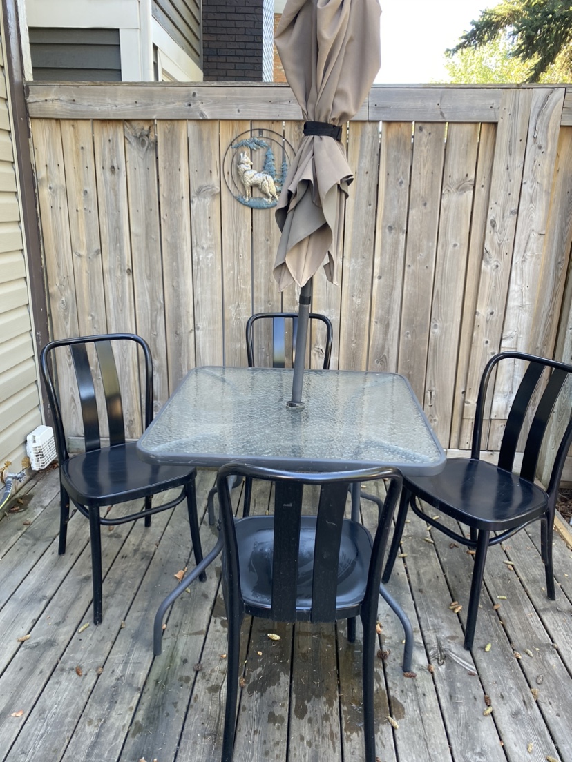 Patio table with umbrella and chair